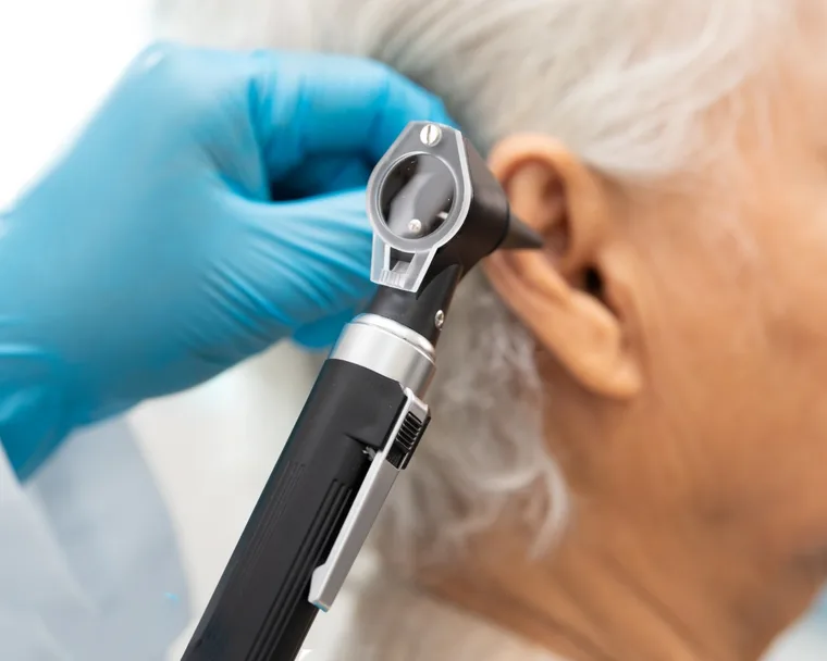 A close-up otoscope examination of a patient’s ear before wax removal