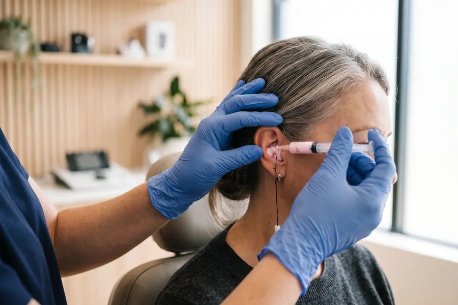 Soft silicone being placed in a patient's ear to take a custom impression