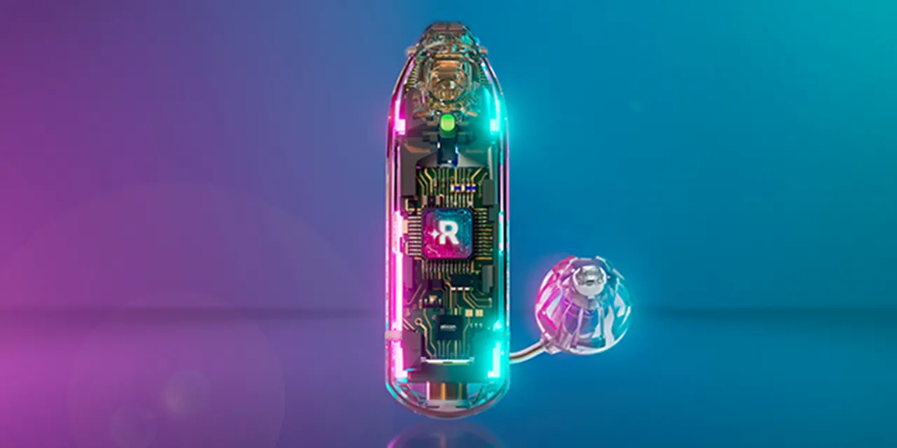 Oticon’s see-through render of the Reveal hearing aid showing the Reveal AI chip lit in magenta and teal