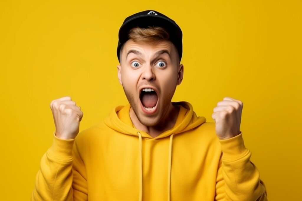 excited man wearing a yellow hoodie