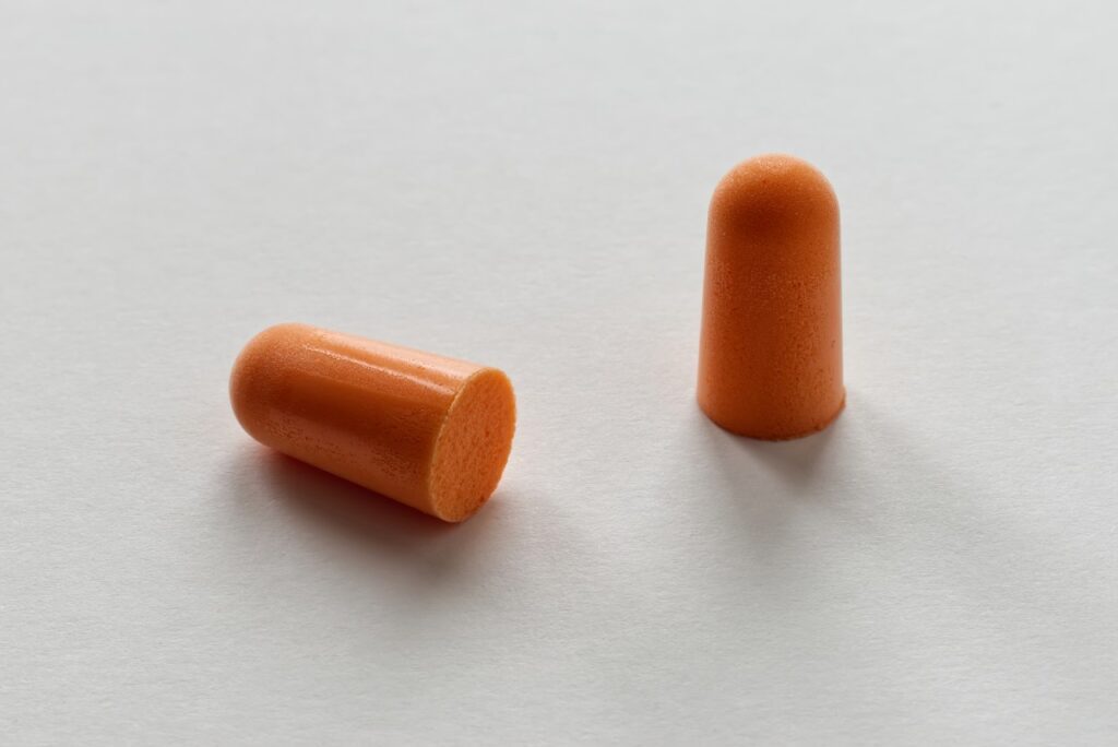 close up shot of orange colored ear plugs