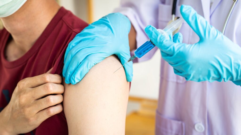patient getting vaccinated by a medical professional