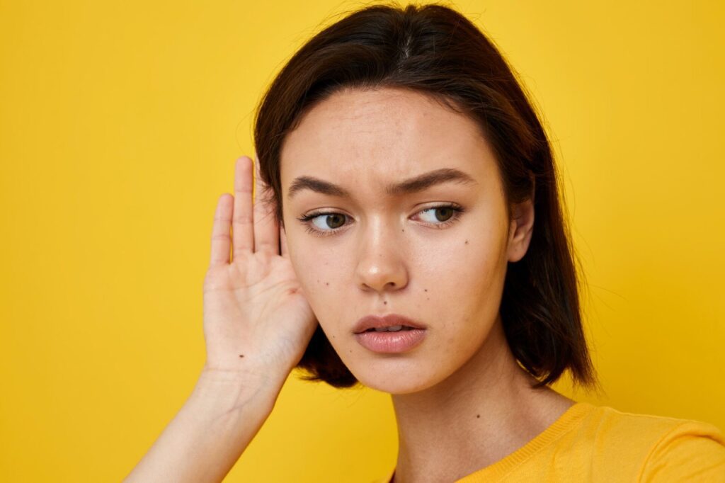 beautiful young woman having problem with her hearing