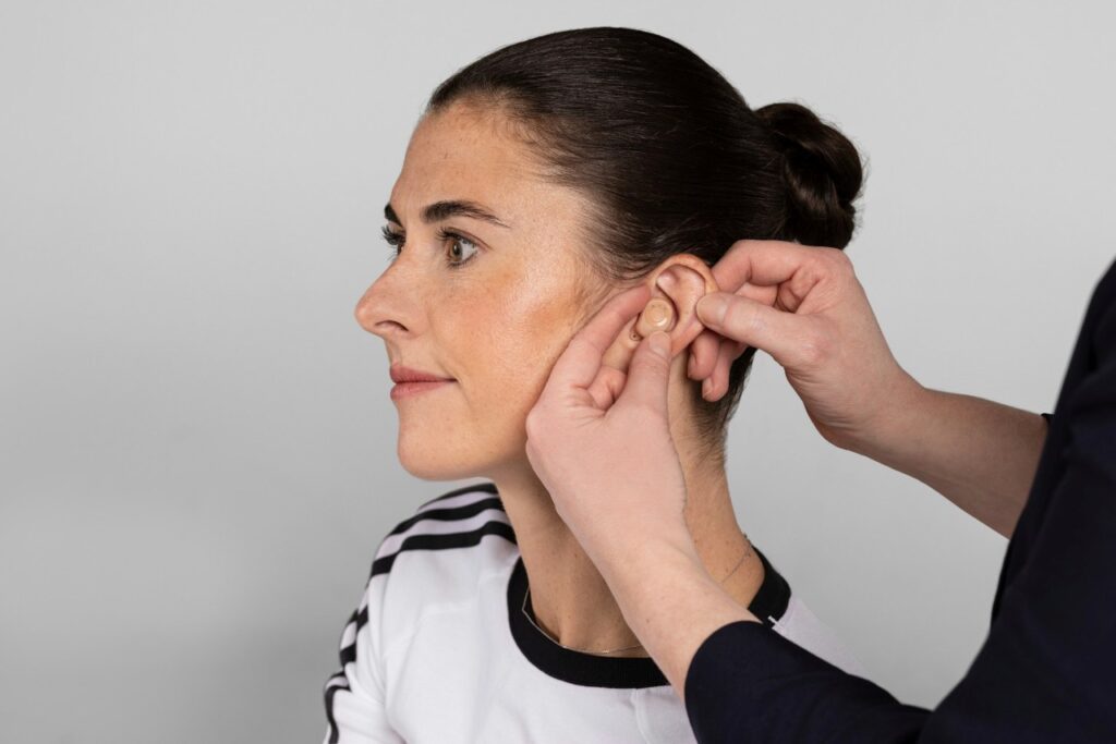 woman being fitted with a hearing aid