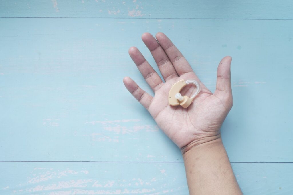 a hand with a hearing aid