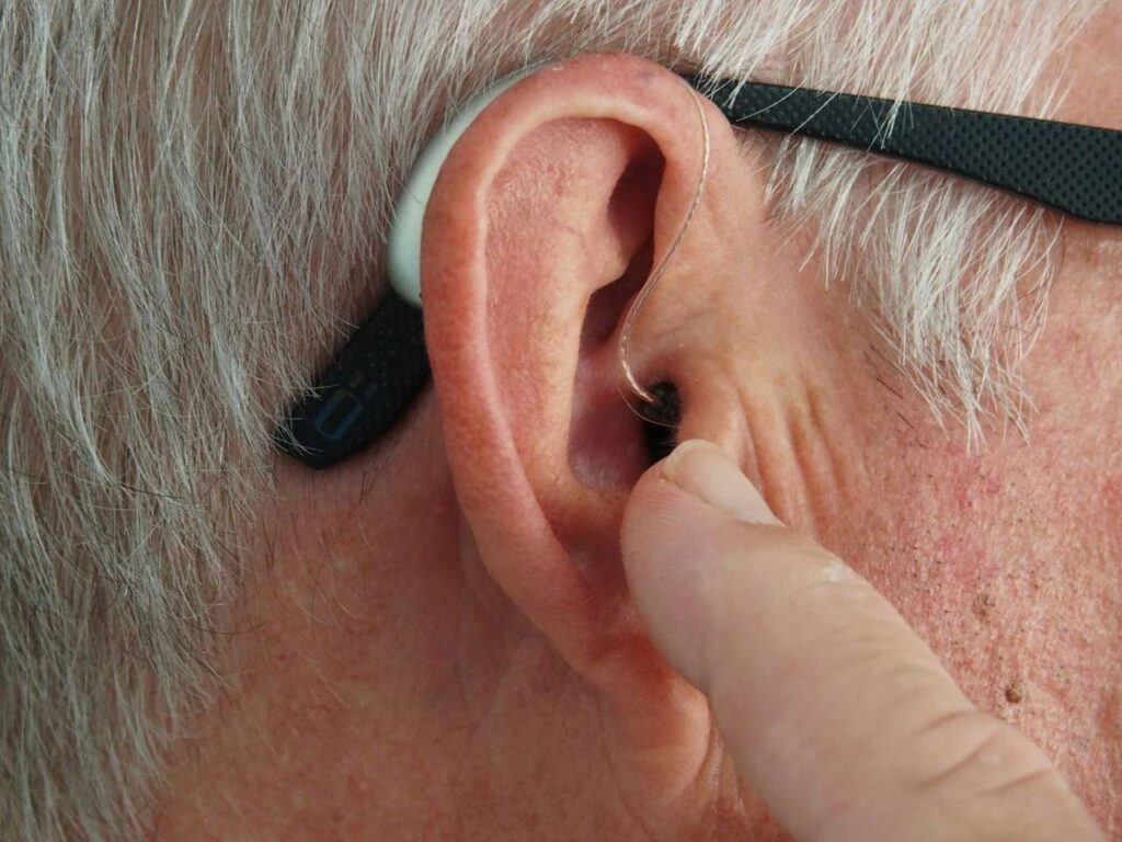 old man wearing invisible hearing aids