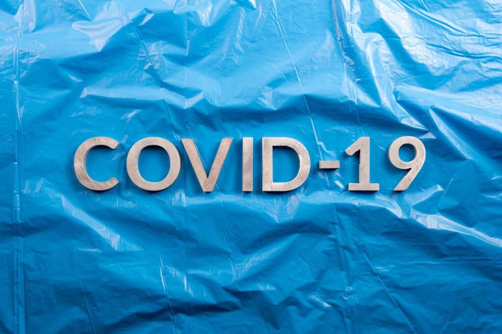 covid 19 on blue plastic background