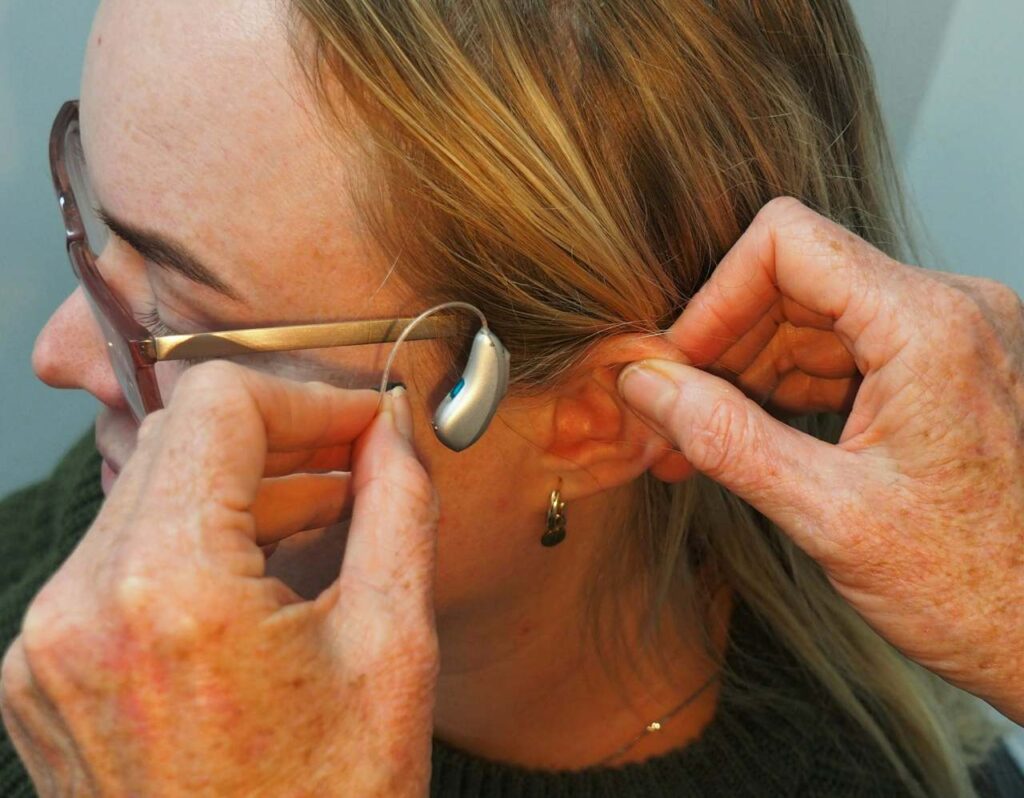 woman being fitted with a new hearing aid