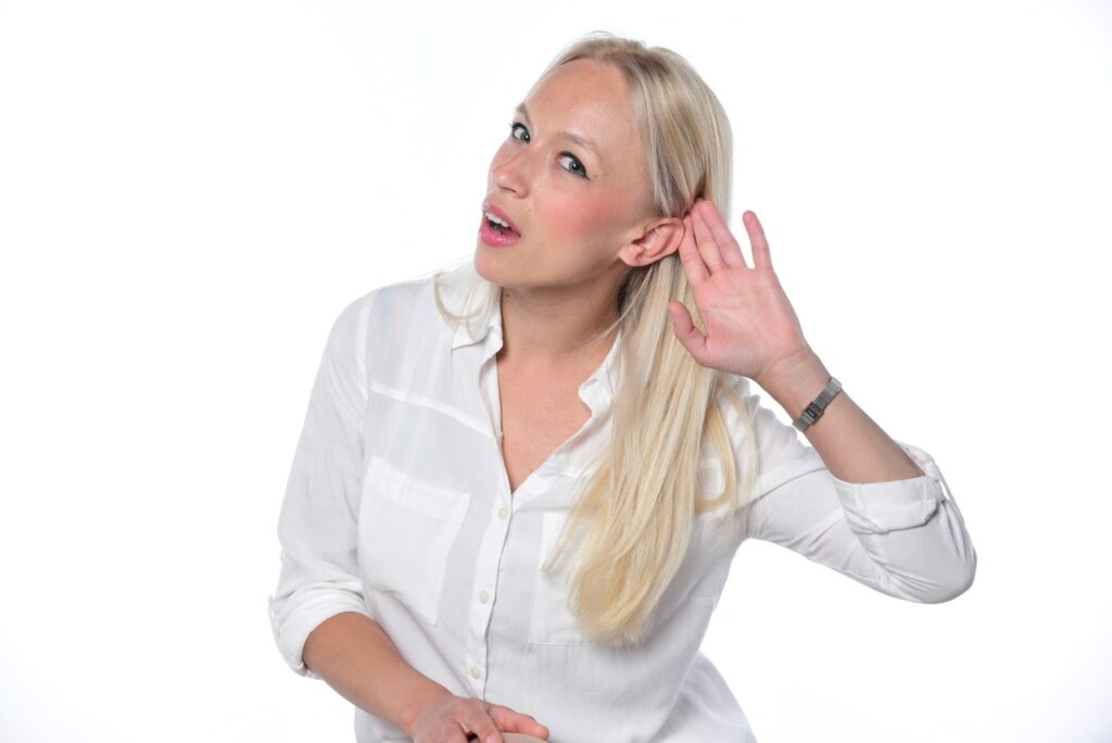 blonde woman having difficulty hearing