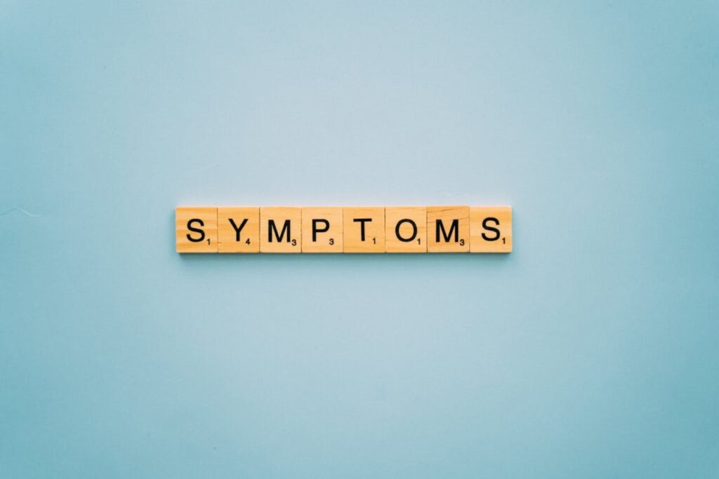 word symptoms spelled on wooden tiles