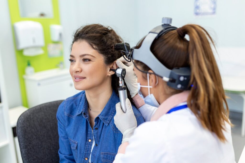 a medical professional examining a patient's ear