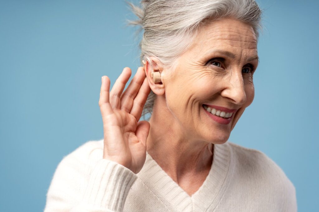 beautiful elderly woman smiling while wearing hearing aid