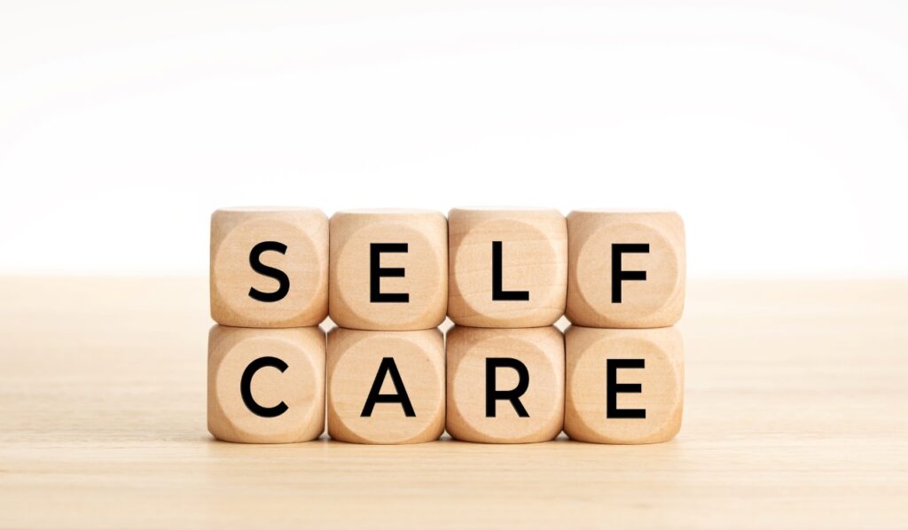 word self care spelled on wooden cubes