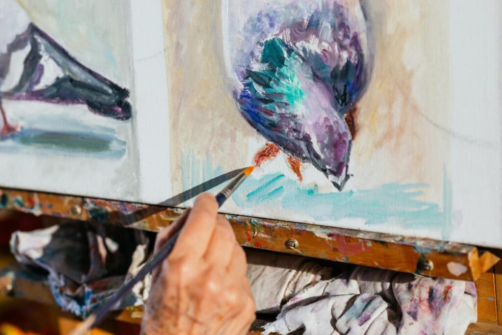hand holding a paint brush painting