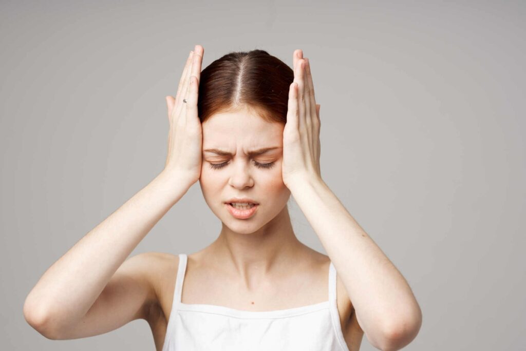 young woman with her hands on her head