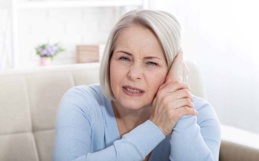 sick female having ear pain