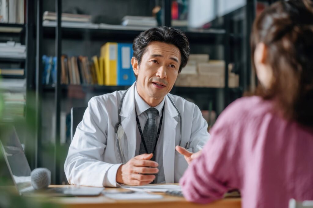 Doctor Consulting Patient Explaining Diagnosis and Treatment