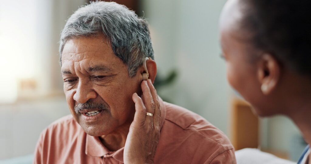 People, healthcare worker and deaf patient with audiology implant, service or help for sound waves